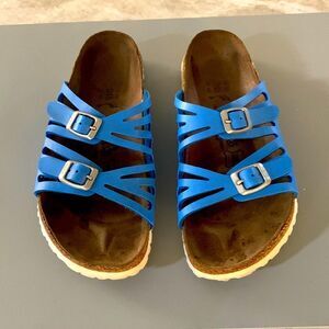 Bright blue buckled Birkies by Birkenstock.